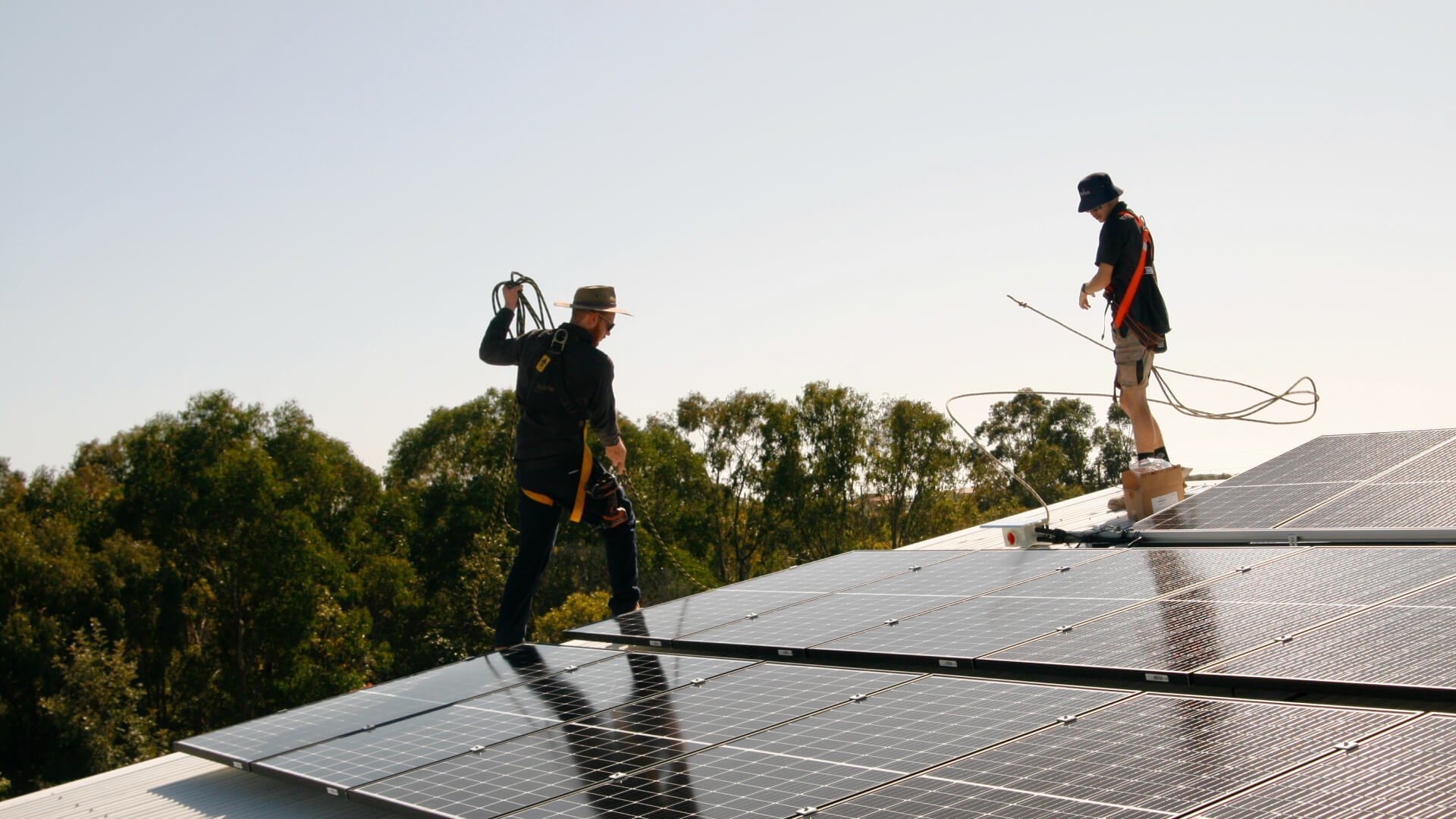 Two solar installers working on the solar system in the roof of a Caloundra property.