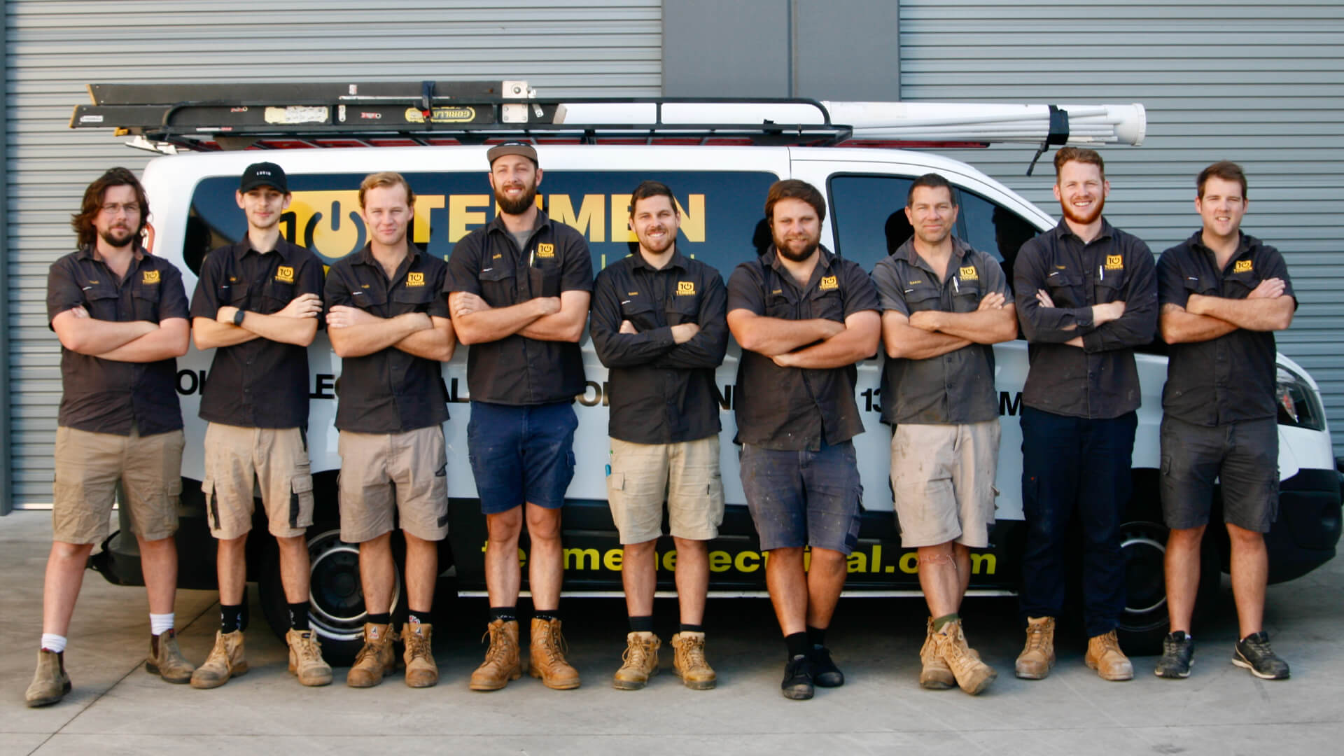 The Tenmen Electrical Kawana team of aircon technicians standing in front of a van the working van.