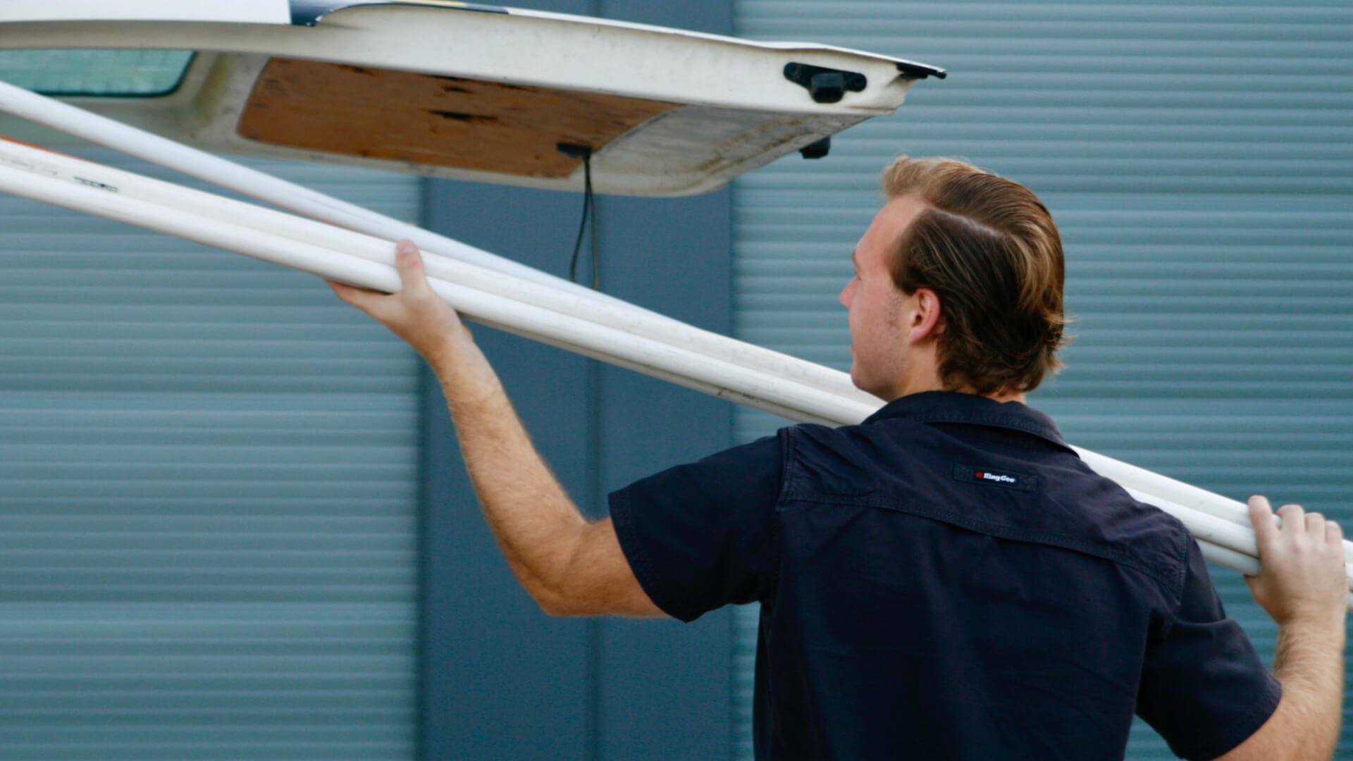 A Sunshine Coast air conditioner technician loading a van with supplies.