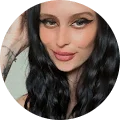 A woman with long black hair and tattoos.