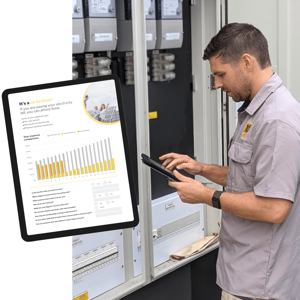 An electrician using a tablet in front of an electrical panel on the Sunshine Coast.