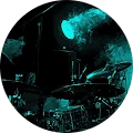 A man playing drums in a blue circle.