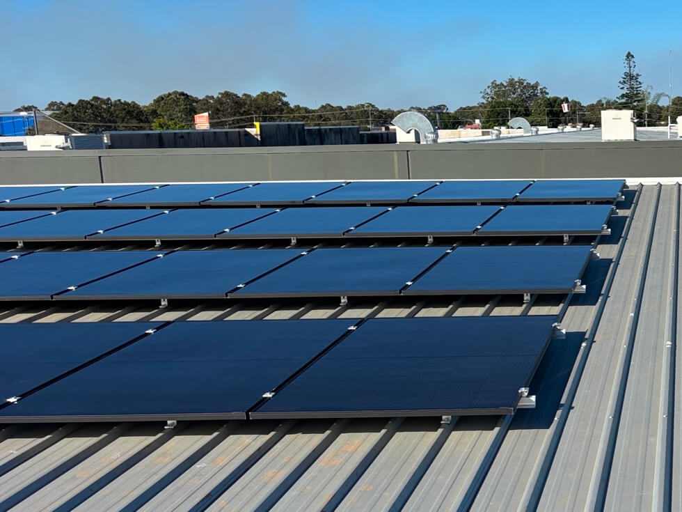Solar panels mounted on a corrugated metal roof.