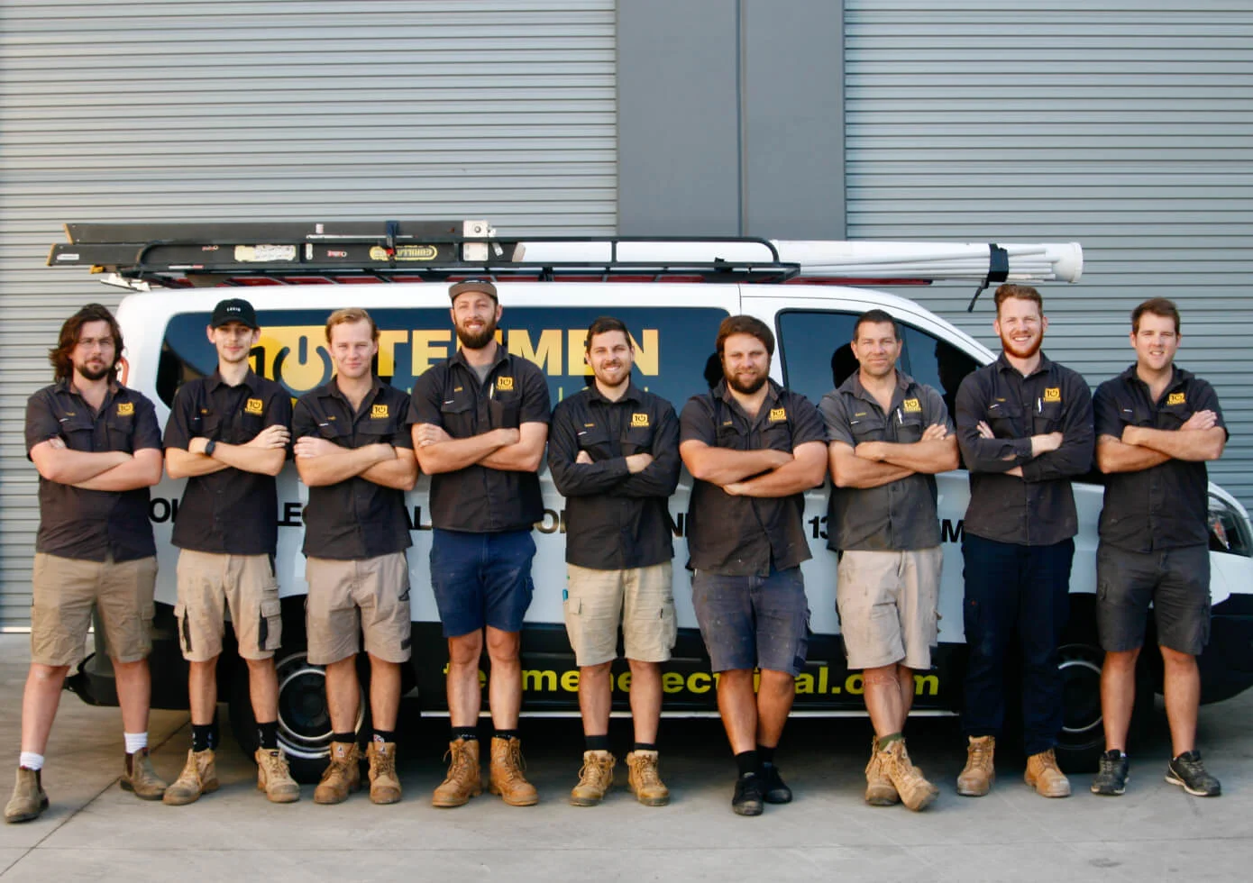 The Tenmen Electrical team of electricians standing in front of a van on the Sunshine Coast.