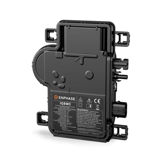 A black Enphase IQ8MC microinverter device with multiple connection ports and a warning label on the front.