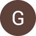 The letter g in a brown circle.