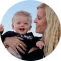 A woman holding a baby in a circle.