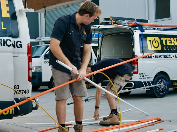 Two local electricians on the Sunshine Coast loading a working van