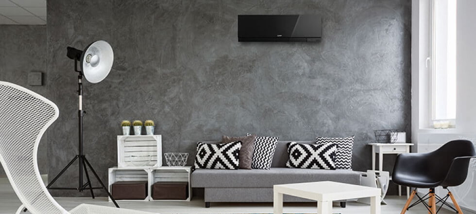 A living room with a grey wall and white furniture, perfect for installing the best air conditioner.