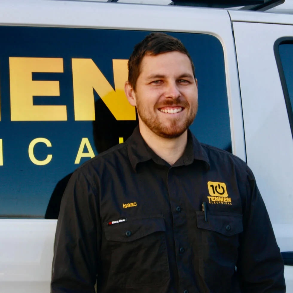 A Coolum electrician, standing in front of a working van