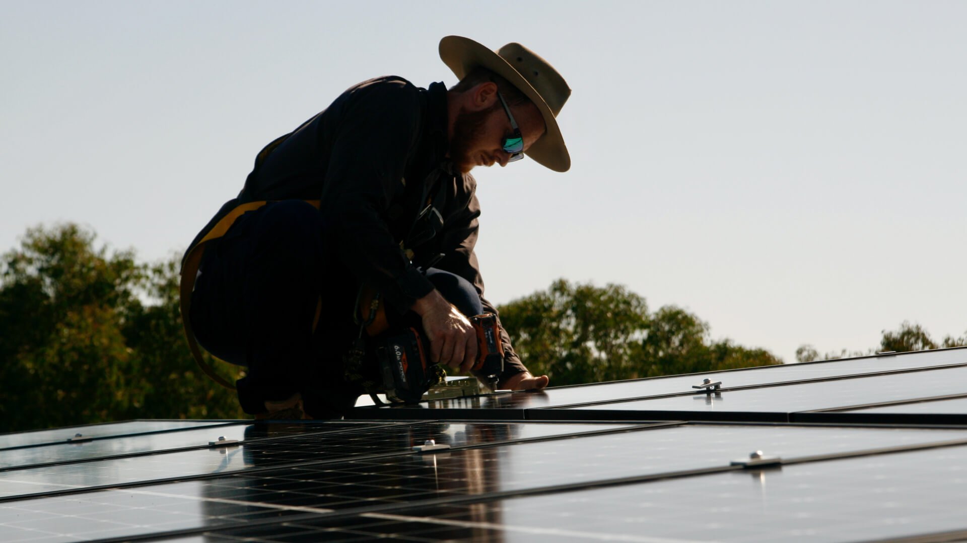 A man providing solar servicing on a roof on the Sunshine Coast.