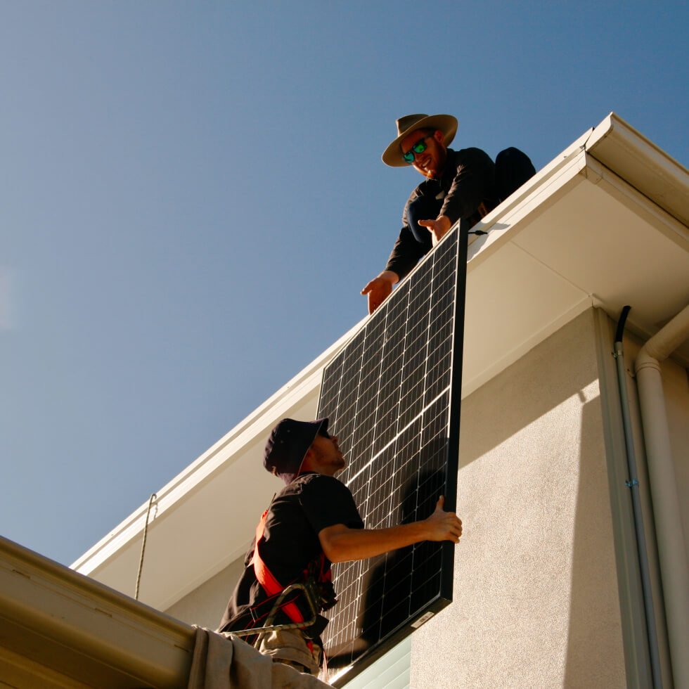 Two men working on a solar panel installation on the sunshine coast.