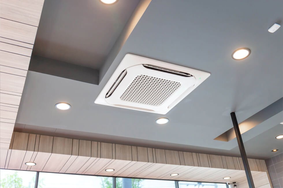 A ceiling mounted air conditioner in a room.