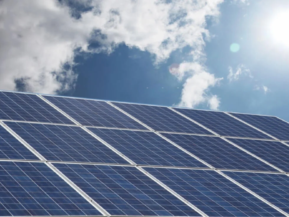 A photo of a solar panel against a blue sky.