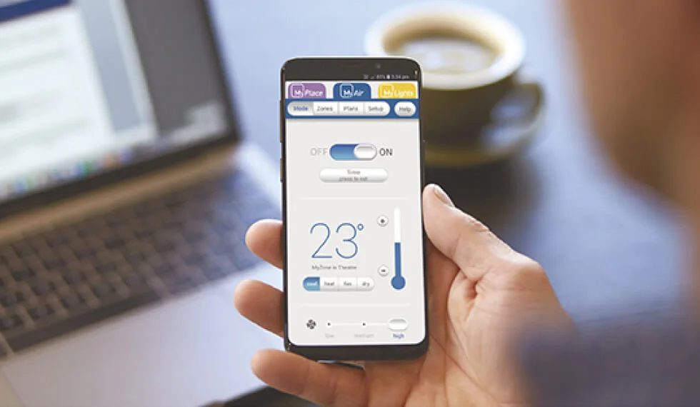 A person holding a smart phone with a thermometer on it.