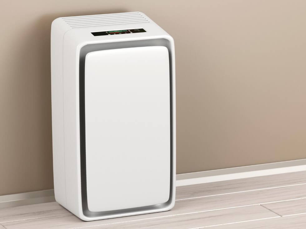 A white air purifier sitting in a room.