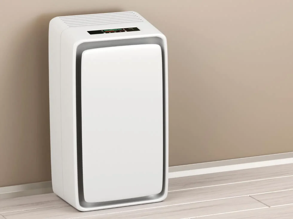 A white air purifier sitting in a room.