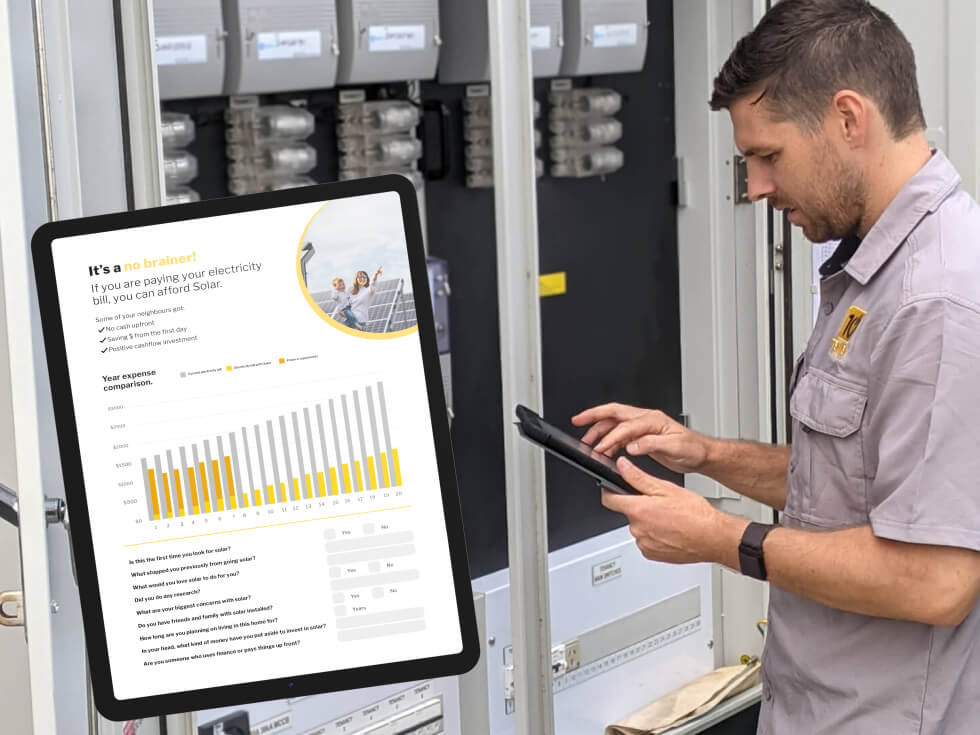 Tenmen solar technician is looking at an ipad in front of an electrical panel.