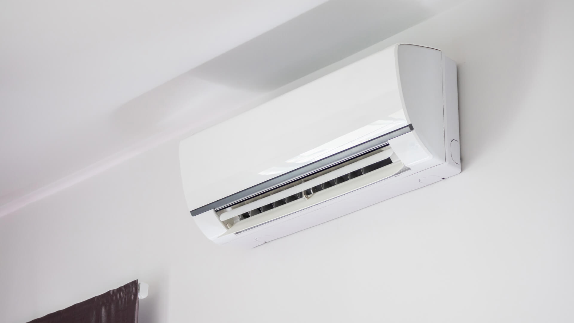 A split-system air conditioner hanging on the wall in a room on the Sunshine Coast.
